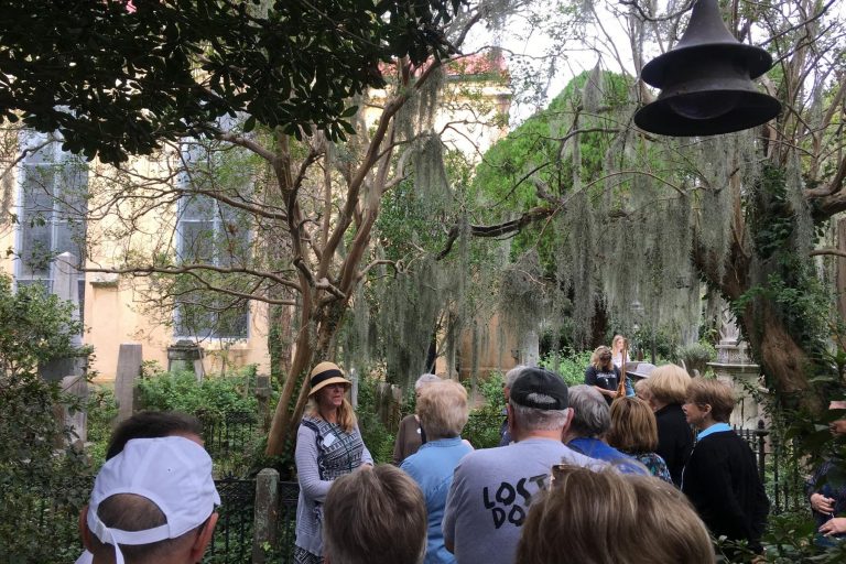 Lee Ann speaking to a tour group inside a historic graveyard.